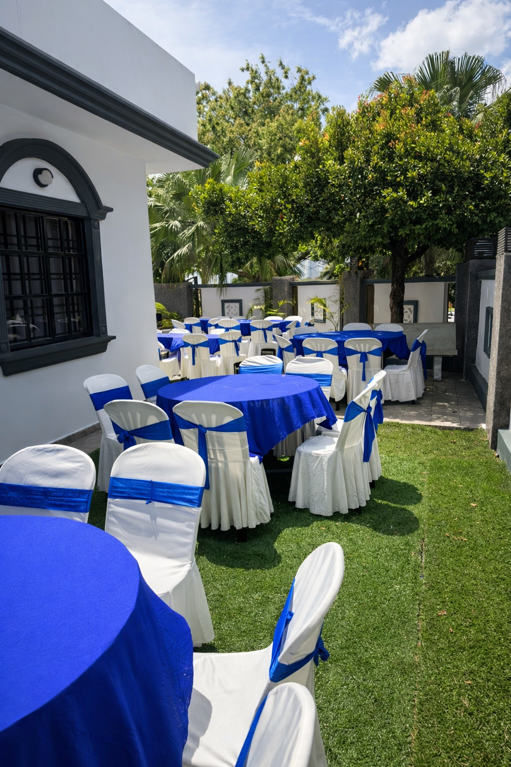 Blue and white event tables arranged in the Villa Rinting garden