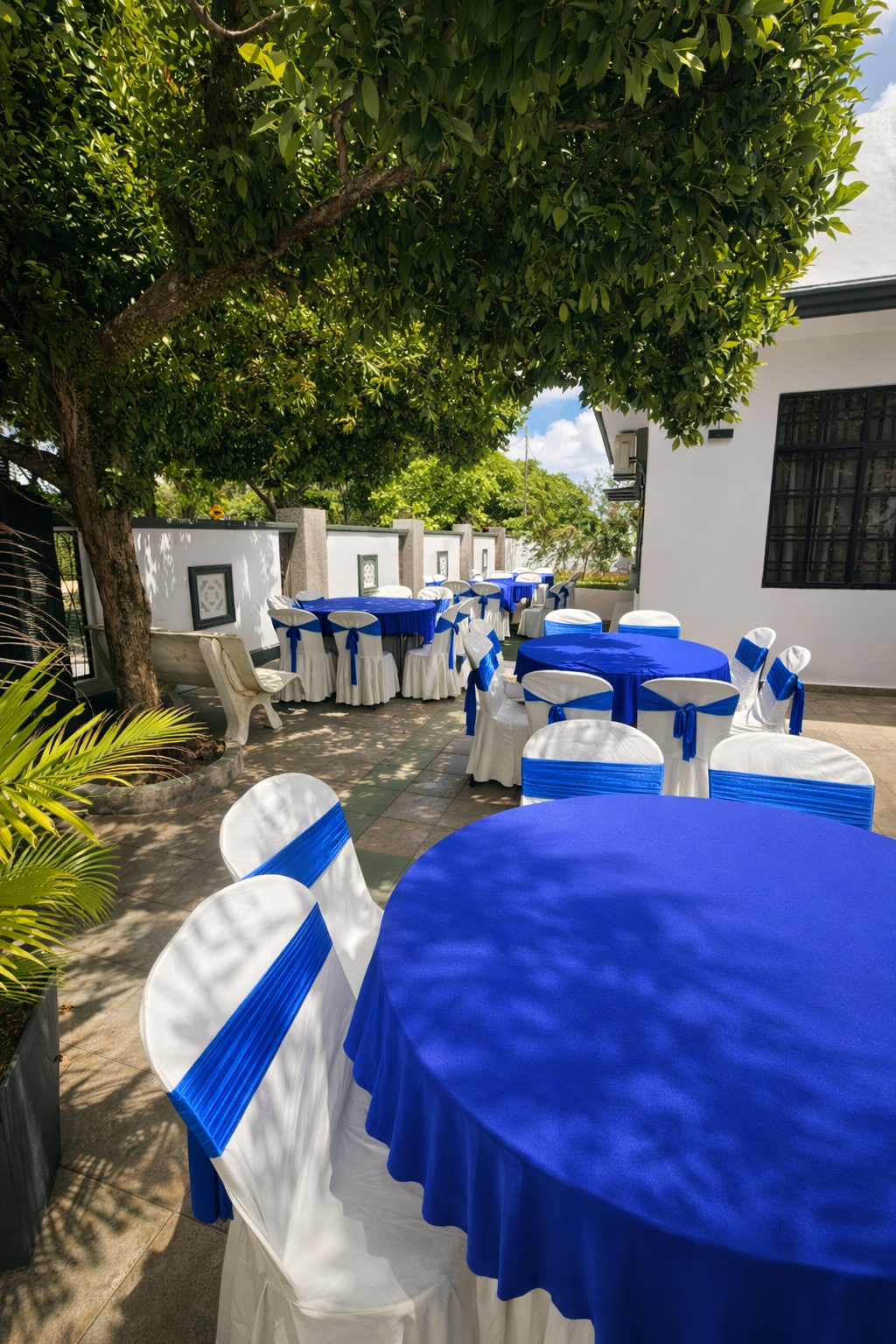 Shaded outdoor gathering setup beneath the trees at Villa Rinting